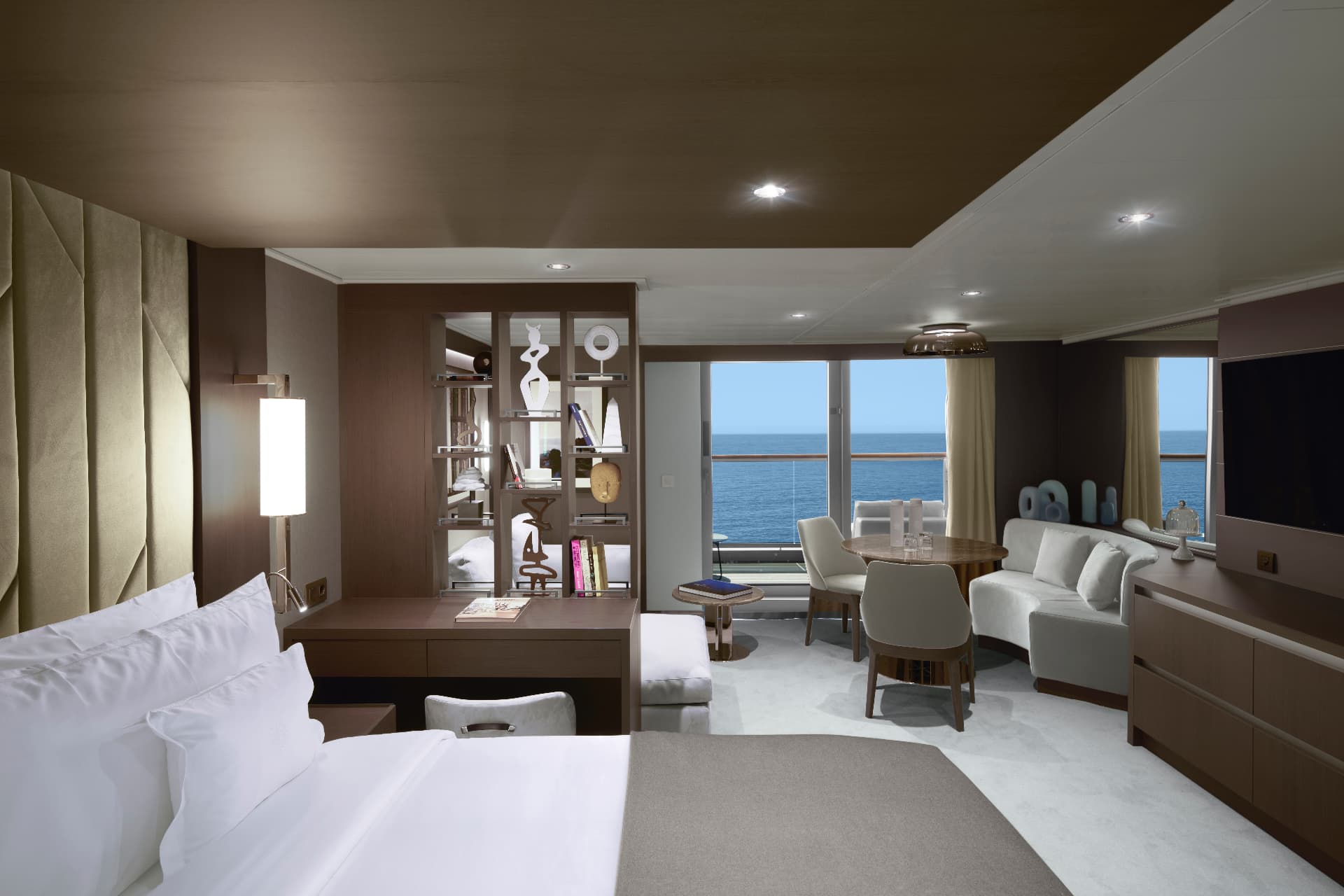 Explora II ocean terrace suite with king bed facing floor-to-ceiling windows