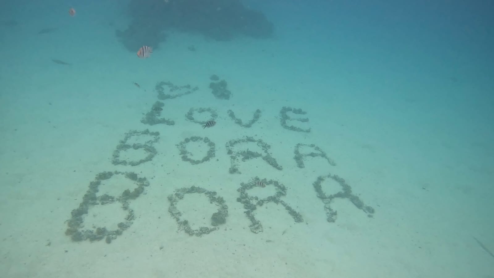 "I love Bora Bora" written in the sand on the Bora Bora lagoon floor, French Polynesia