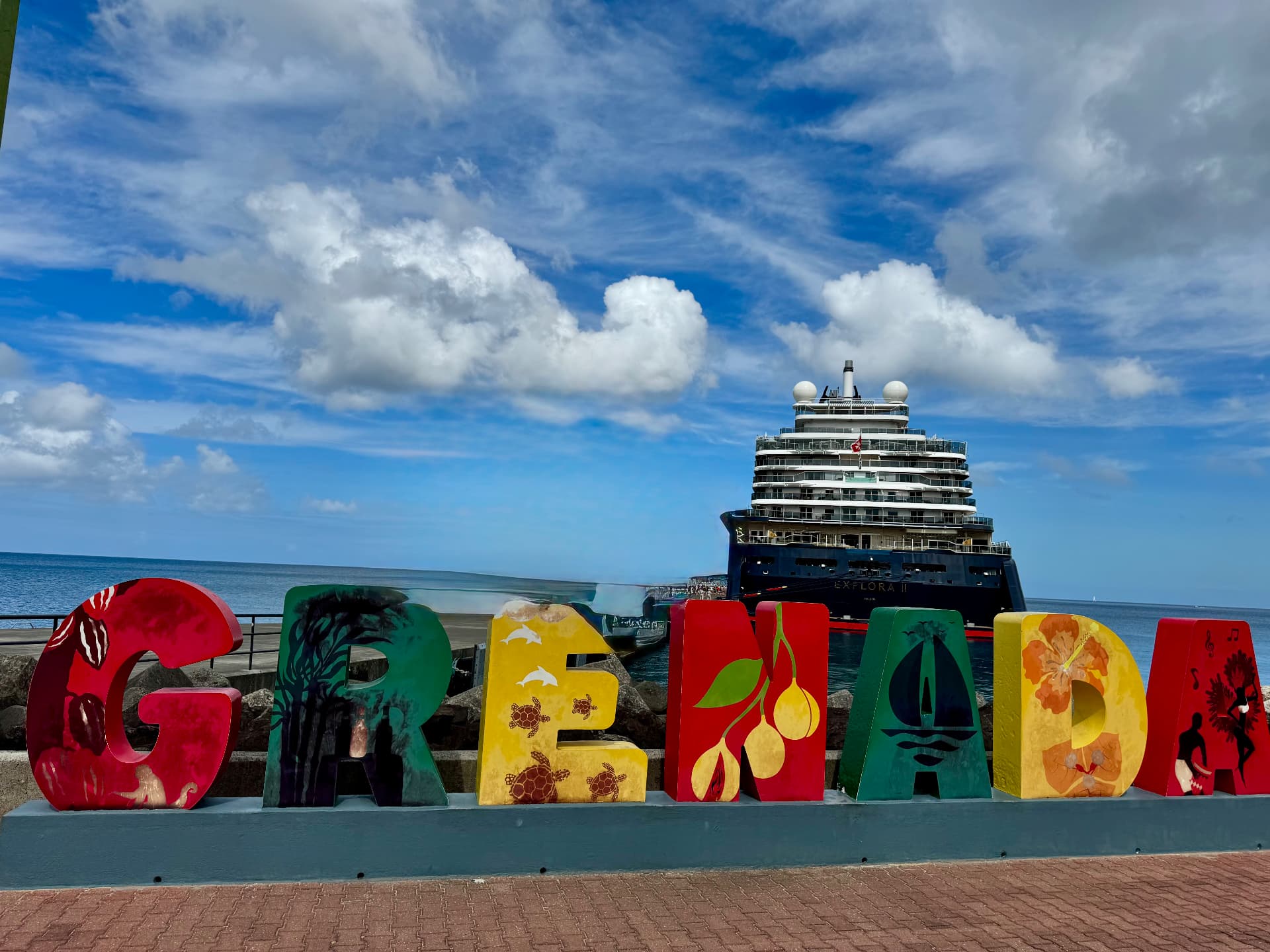 EXPLORA II docked in Grenada behind the colorful Grenada letter sign