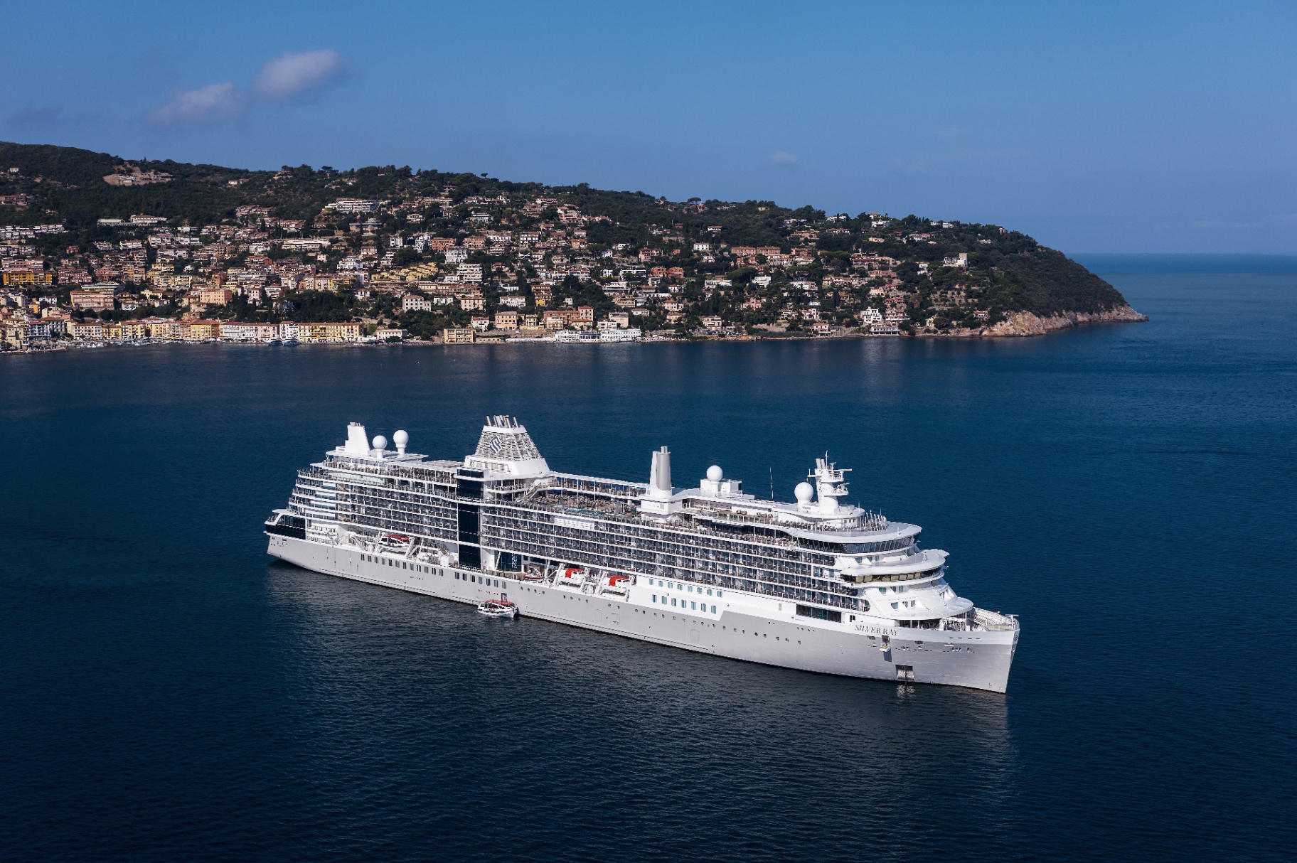 Expedition cruise ship in dramatic fjord landscape